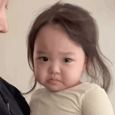 Little Girl Making Funny Face Held By Woman GIF