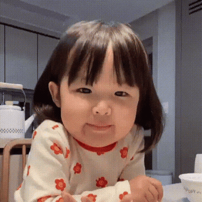 Little Girl Making Funny Face In Kitchen GIF