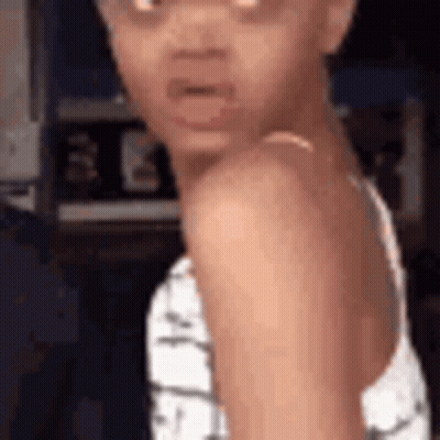 Little Girl Making Funny Face In White Tank Top GIF
