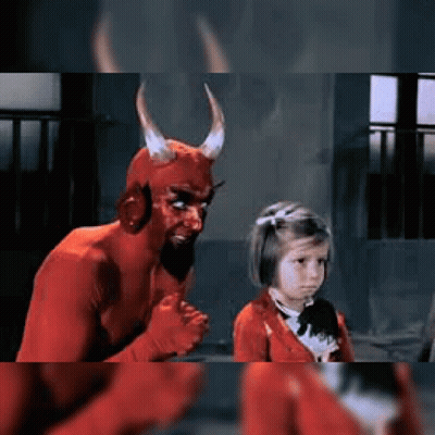 Little Girl Next To Man In Devil Costume GIF