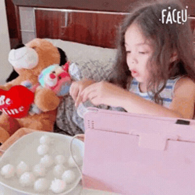 Little Girl Playing Tablet Next To Teddy Bear Saying Be Mine GIF