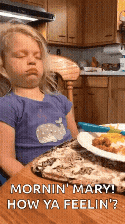 Little Girl Sitting At Table With Food GIF