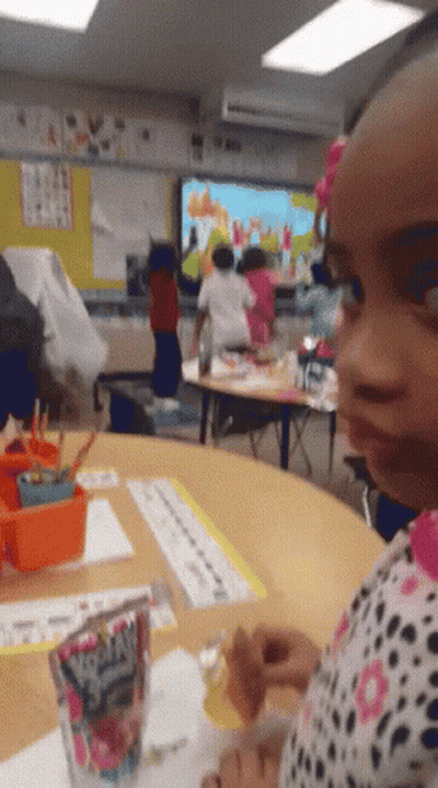 Little Girl Sitting At Table With Fruity Pebbles GIF