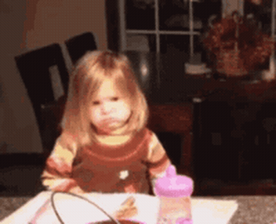 Little Girl Sitting At Table With Water Bottle GIF