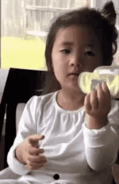 Little Girl Sitting Holding Water Bottle GIF
