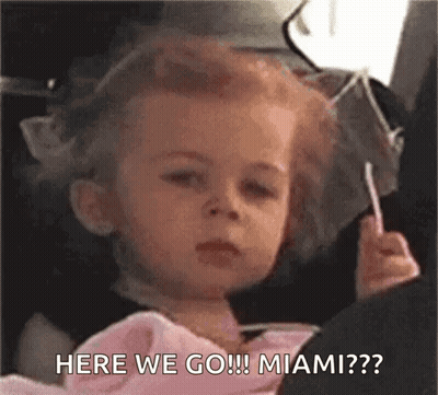 Little Girl Sitting In Car Holding Lollipop Making Face GIF