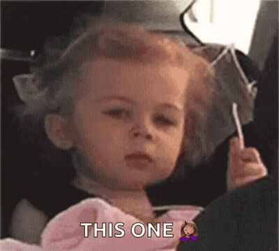Little Girl Sitting In Car Seat Holding Lollipop GIF
