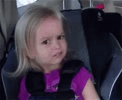 Little Girl Sitting In Car Seat With Purple Shirt GIF