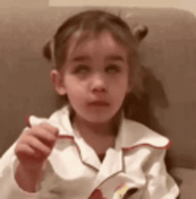 Little Girl Sitting In Chair Holding Paper GIF