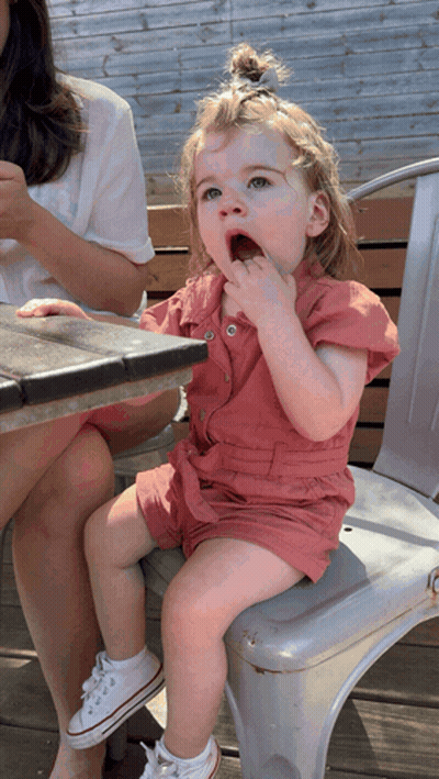 Little Girl Sitting On Chair Eating GIF