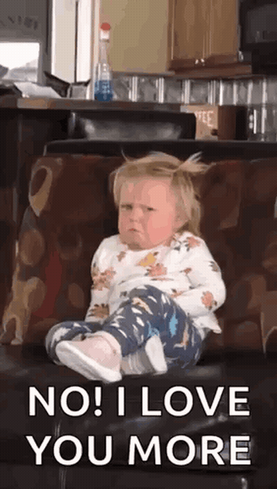 Little Girl Sitting On Couch With Legs Crossed Making Face GIF