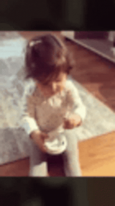 Little Girl Sitting On Floor Eating GIF