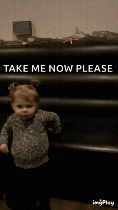 Little Girl Standing In Front Of Shelf GIF