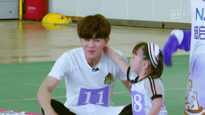 Little Girl Touching Man With Number 11 Shirt GIF