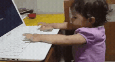 Little Girl Typing on Laptop