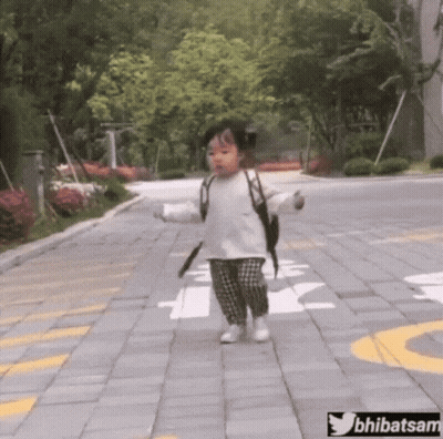 Little Girl Walking Down Brick Sidewalk With Backpack GIF