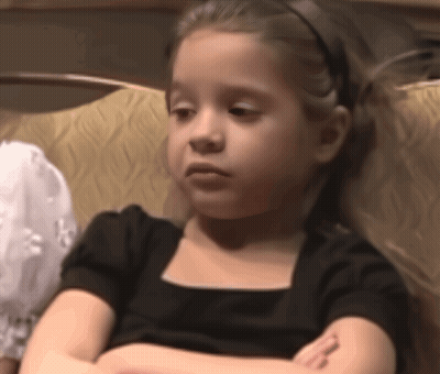 Little Girl With Arms Crossed In Black Dress GIF