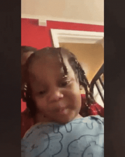 Little Girl With Braids Sitting In Chair Making Face GIF