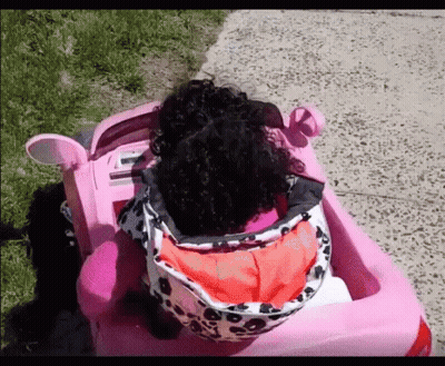 Little Girl With Curly Hair In Pink Car GIF