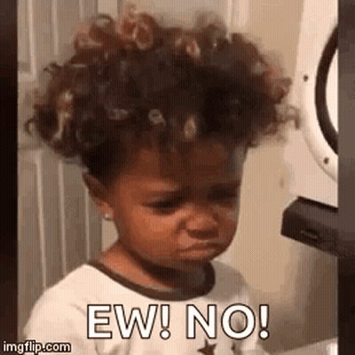 Little Girl With Curly Hair Making Funny Face By Washing Machine GIF