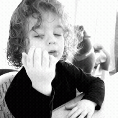 Little Girl With Curly Hair Sitting With Hand On Face GIF