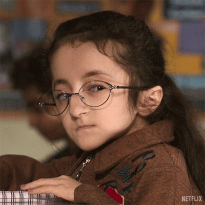 Little Girl With Glasses At Desk And Netflix Logo GIF