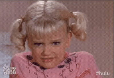Little Girl With Pigtails Making Funny Face In Pink Shirt GIF