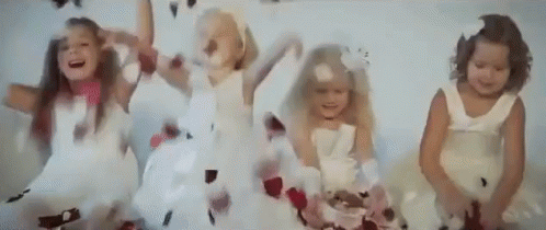 Little Girls In White Dresses Jumping With Feathers GIF