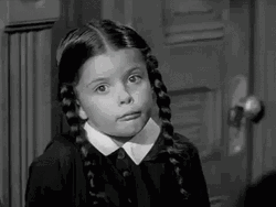 Little Wednesday Addams Shrugging Shoulder GIF