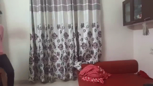Living Room Red Couch And Floral Curtains GIF