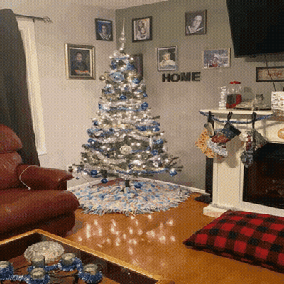 Living Room With Christmas Tree And Home Sign GIF