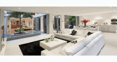 Living Room With White Sectional Couch And Coffee Table GIF