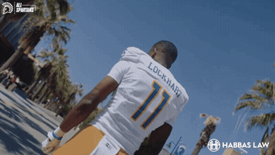 Lockhart Football Player Walking Down Street GIF
