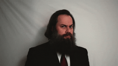 Long Bearded Man In Black Suit Red Tie GIF