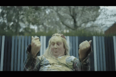 Long Blonde Hair Man Sitting By Striped Fence GIF