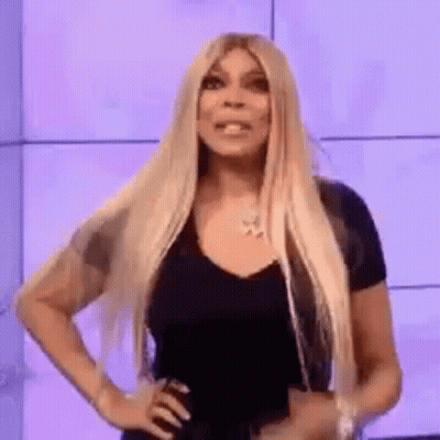 Long Blonde Hair Woman Hands On Hips Looking At Camera GIF