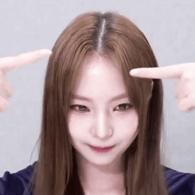 Long Brown Haired Woman Pointing At Forehead GIF