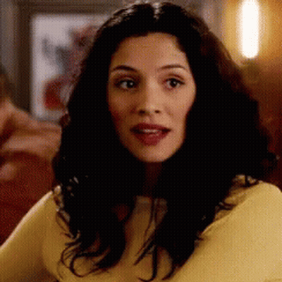Long Dark Hair Woman In Yellow Shirt Looking GIF