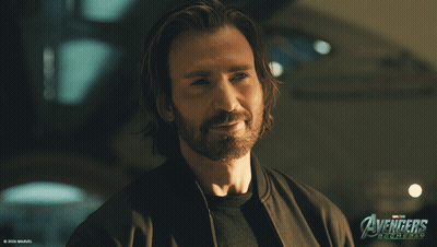 Long Hair Beard Man Smiling In Front Of Avengers Age Of Ultron Poster GIF