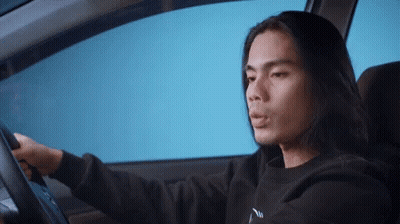 Long Hair Man Driving Car In Black Sweatshirt Saying N GIF
