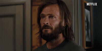 Long Haired Bearded Man In Front Of Netflix Logo GIF