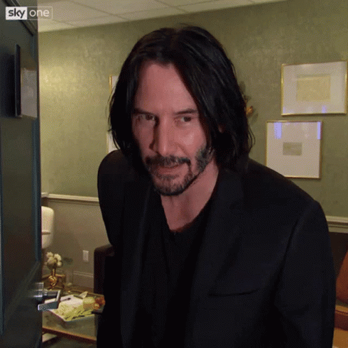 Long-Haired Bearded Man In Front Of Sky One Door GIF