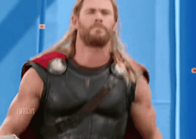 Long Haired Bearded Man In Superhero Costume Blue Wall GIF