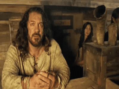 Long Haired Bearded Man With Woman Behind GIF