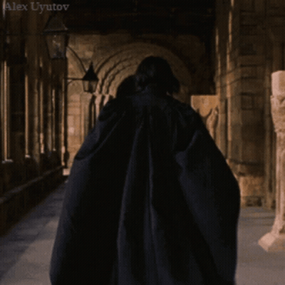 Long-Haired Man Hand On Chin In Dark Room GIF