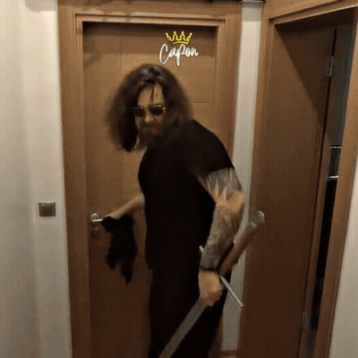 Long Haired Man Holding Sword At Capon Door GIF
