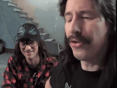 Long-Haired Man In Glasses And Black V Shirt GIF