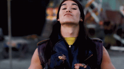 Long-Haired Man In Purple Vest And Yellow Shirt GIF