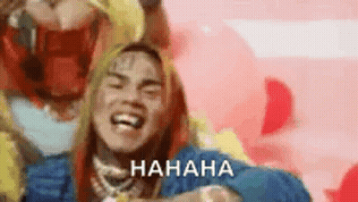 Long Haired Man Laughing In Pink Background Blue Jacket GIF