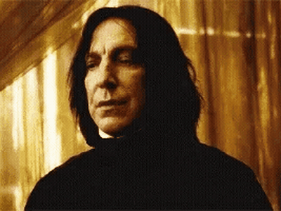 Long-Haired Man Looking At Camera Through Window GIF